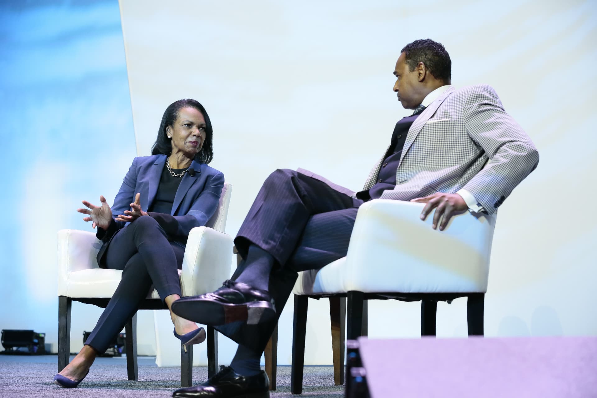 Dwayne Ballen listening as Condoleezza Rice speaks during a main-stage session