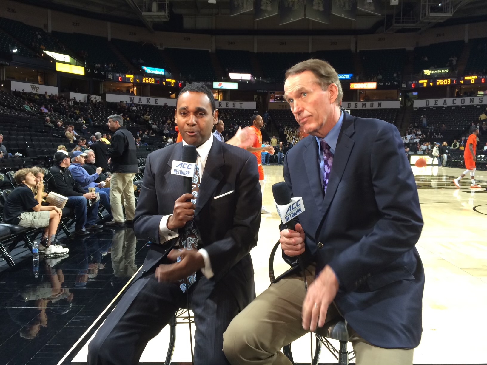 Dwayne Ballen with an ACC Network microphone courtside at a Wake Forest basketball arena